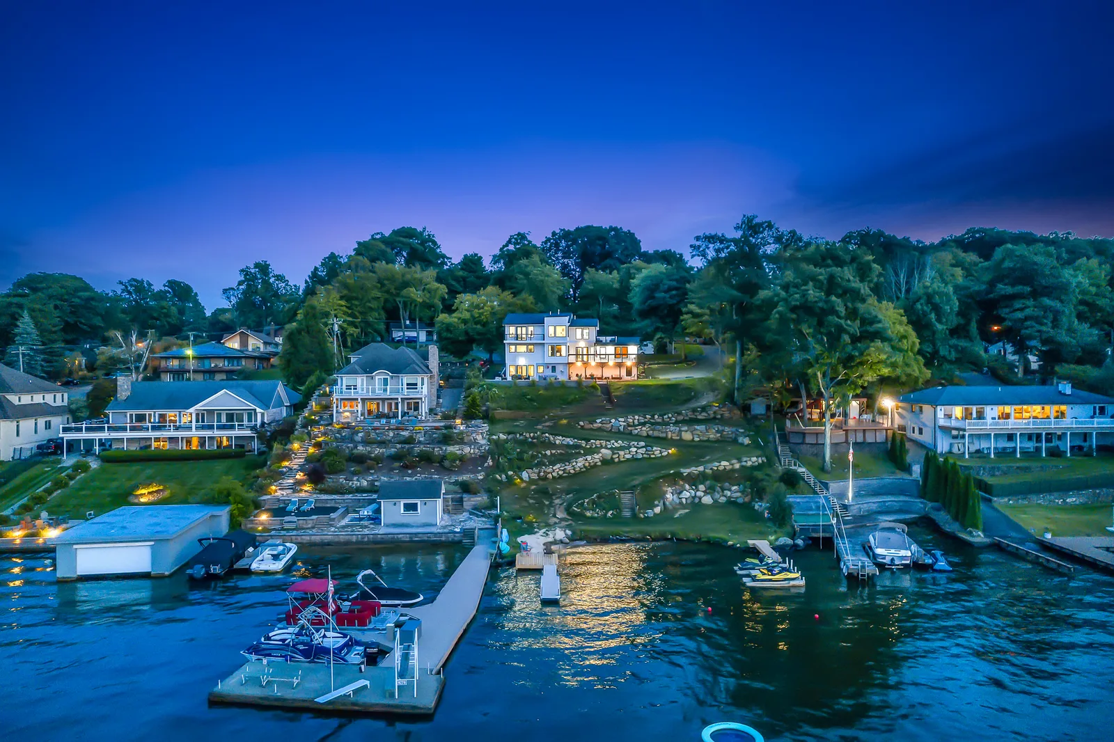 Lake Hopatcong from the air at dusk, the water pale between dark wooded shores