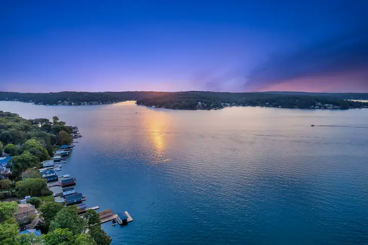The open lake from above, the far shore low and green