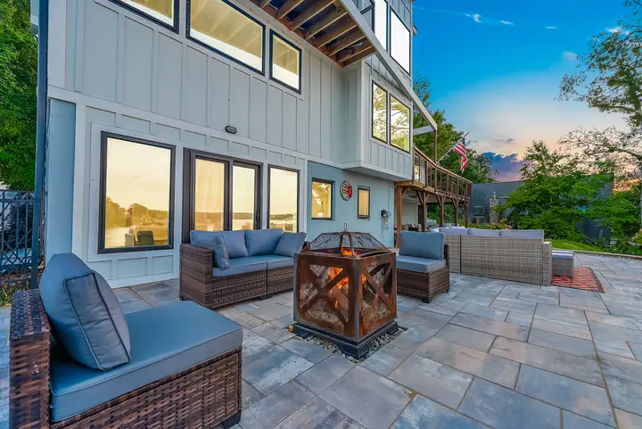 Chairs around a fire pit on the stone patio