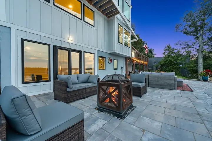 Chairs around a fire pit on the stone patio