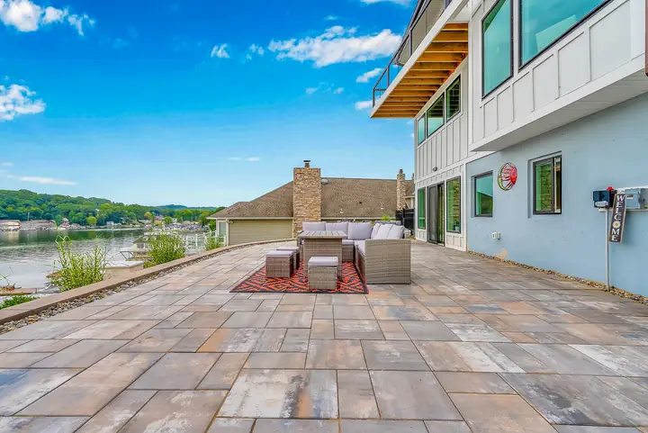 The stone patio running to the lake's edge