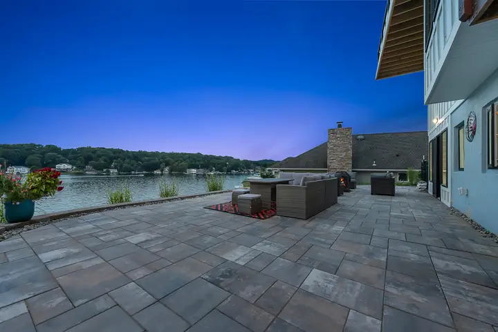 The stone patio running to the lake's edge